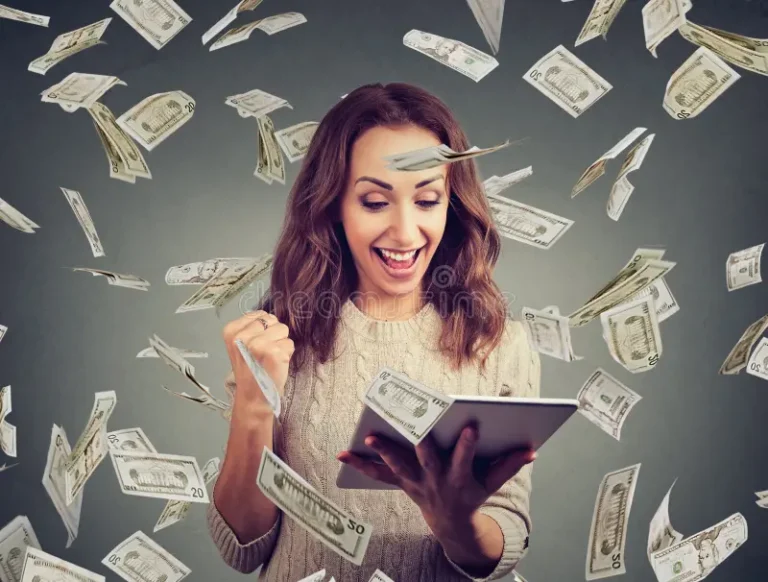 excited-woman-having-online-win-cheerful-table-happy-lottery-holding-fist-up-money-flying-around-118185733